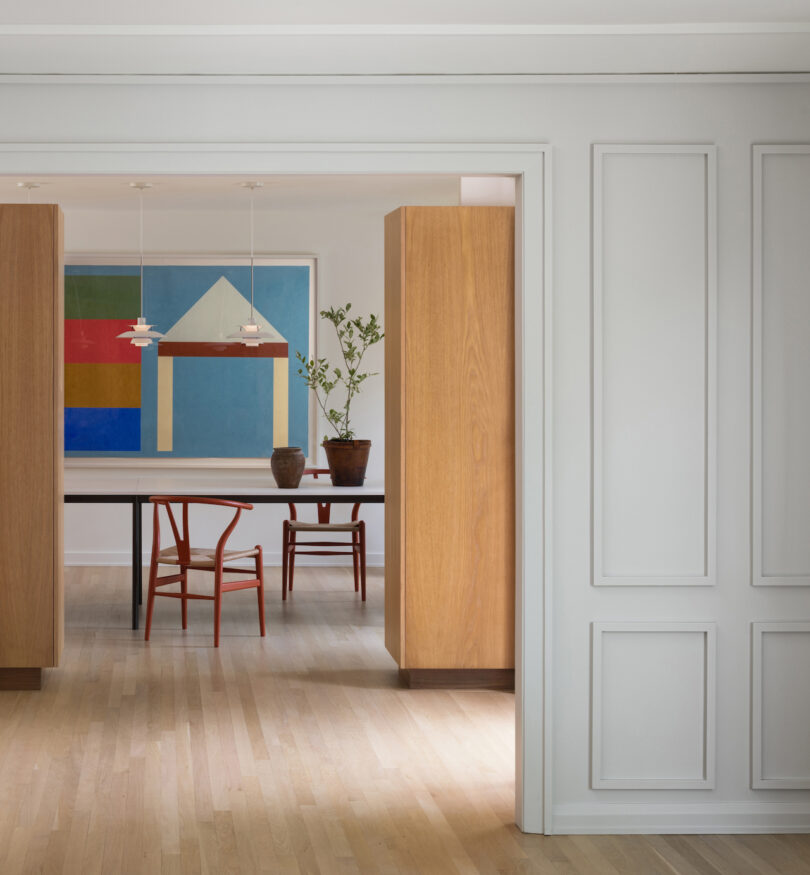 dining table underneath two pendant lights in open floor plan home