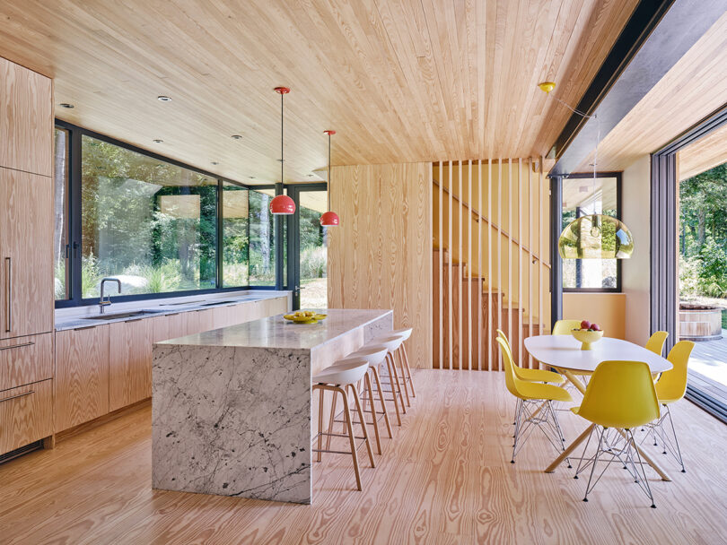 A modern kitchen with wooden features and marble countertops.