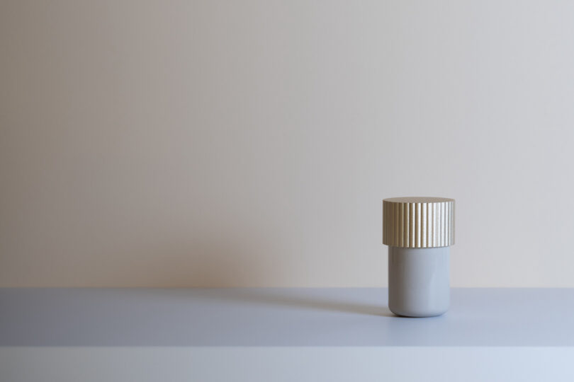 metal storage box with a gold top on a grey table